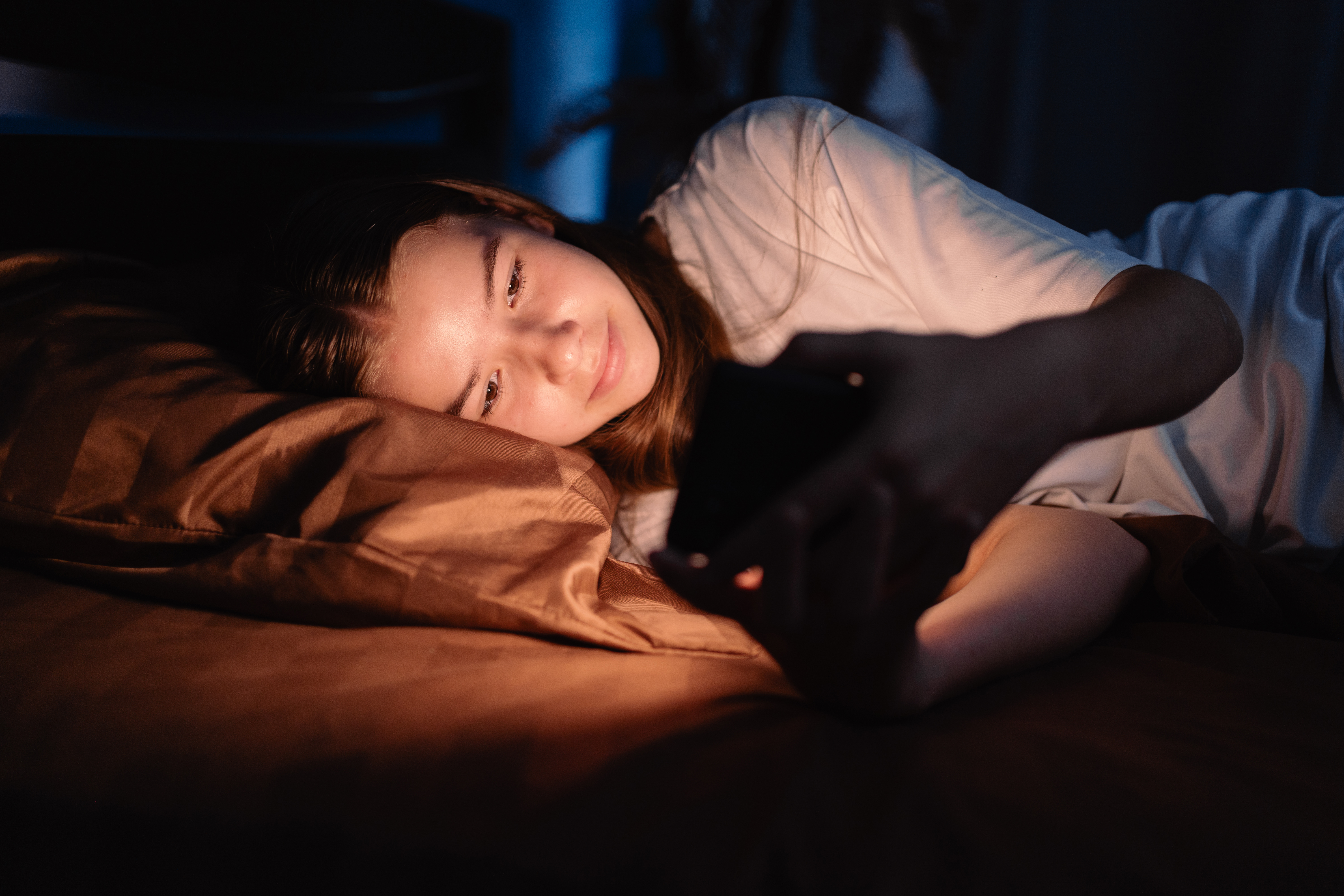 image of teen sad with cellphone